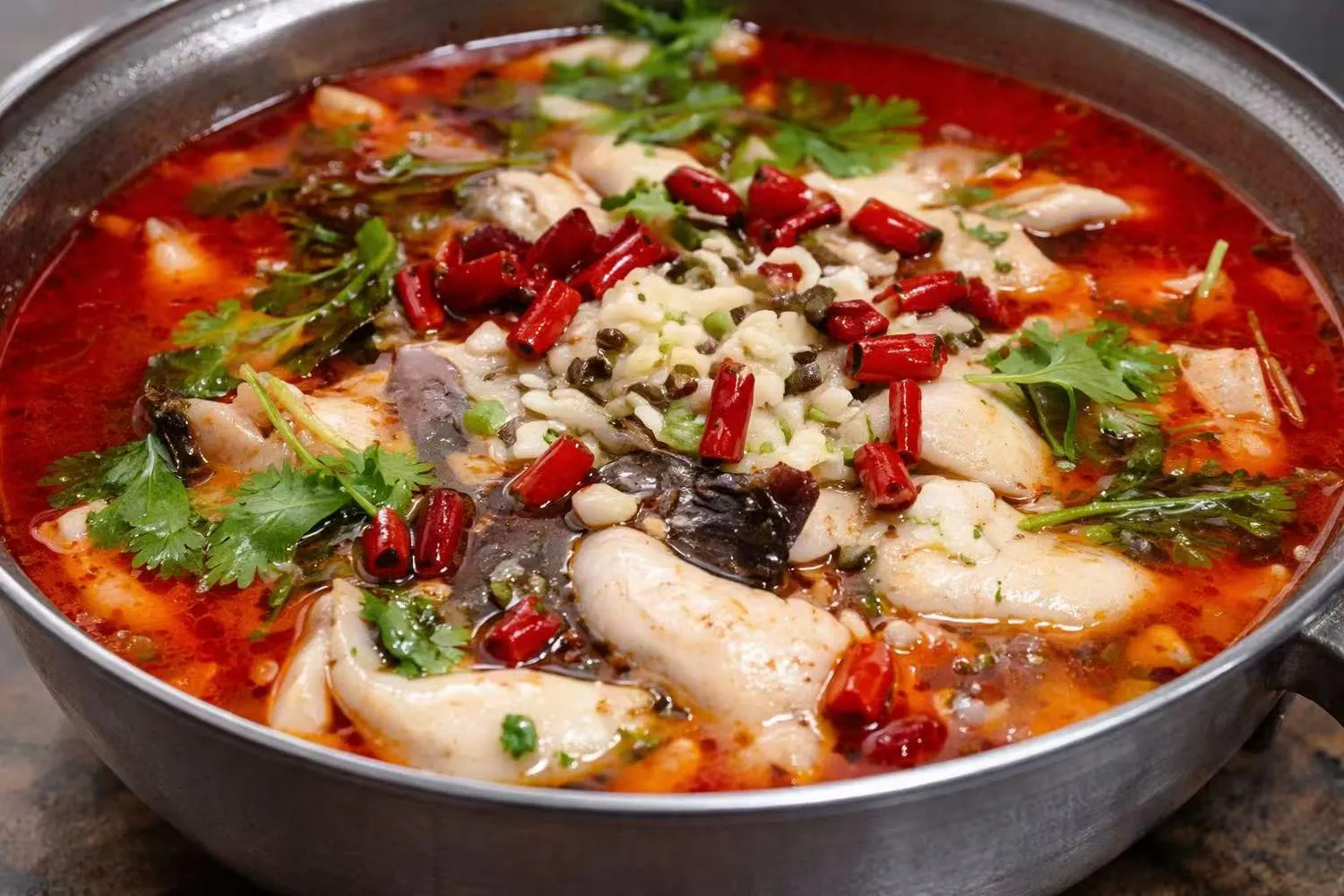 Spicy fish soup in red chili oil with dried chilies, Sichuan peppercorns, and cilantro